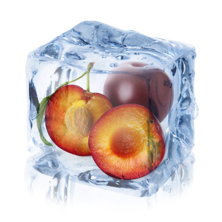Plums inside ice cube isolated on whiteの写真素材