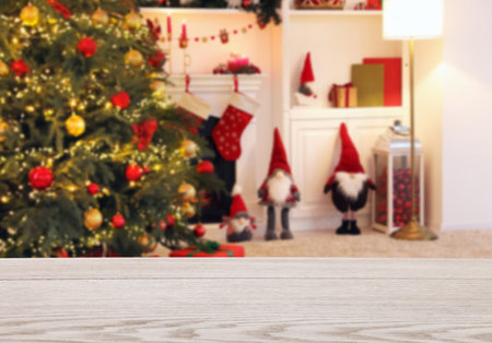 Empty white wooden table in room decorated for Christmas, bokeh lights. Space for designの写真素材