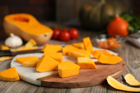 Fresh pumpkins, peels and ingredients on wooden table, closeupの写真素材