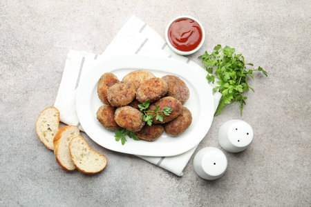 Tasty meat patties served on gray table, flat layの写真素材