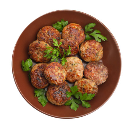 Delicious patties with parsley in bowl isolated on white, top viewの写真素材