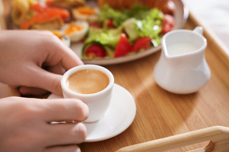 Man having breakfast in bed, closeup. Hotel room serviceの写真素材
