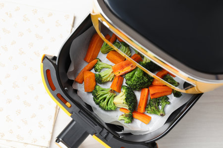 Grilled vegetables in air fryer on white table, top viewの写真素材