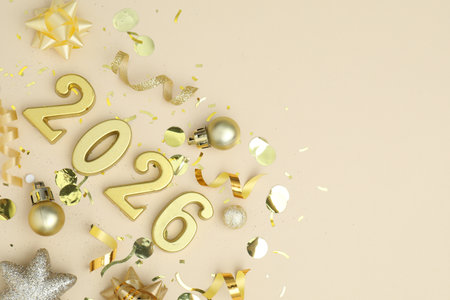 New 2026 Year. Golden numbers, shiny baubles and confetti on beige background, flat lay. Space for textの写真素材