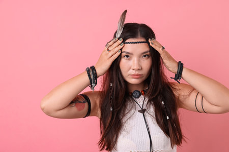 Shaman woman in feather headdress on pink background