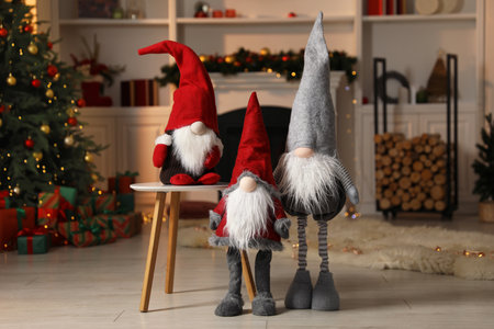 Funny Christmas gnomes in festive decorated roomの写真素材