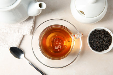 Delicious tea and brew on white table, flat layの写真素材