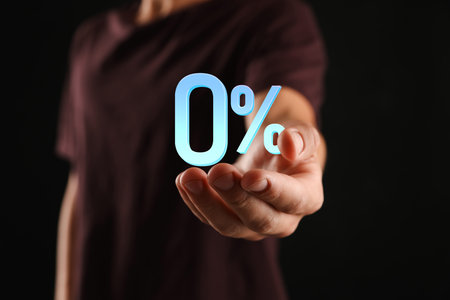 Man holding 0 percent sign in hand against black background, closeup. Zero commissionの写真素材
