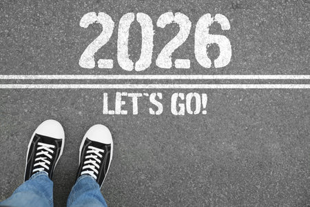 New Year. Man standing in front of lines with the phrase Let's Go! and numbers 2026 on asphalt, top...