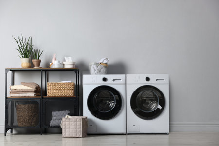 Washing machine and clothes dryer in spacious laundry roomの写真素材
