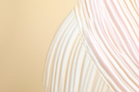 Sample of cosmetic product on beige background, closeup. Space for textの写真素材