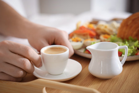 Man having breakfast in bed, closeup.の写真素材