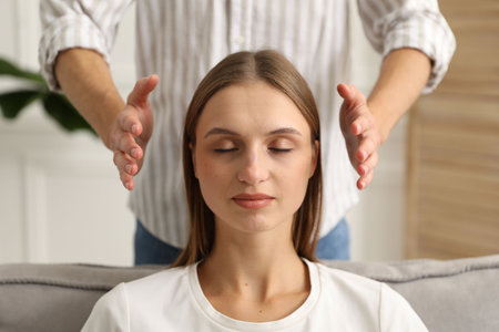 Reiki master healing patient's aura during therapy indoors, closeupの写真素材