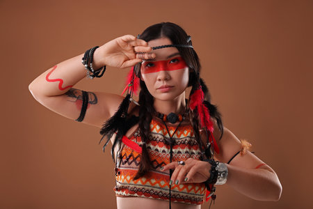 Shaman woman with face painting on brown backgroundの写真素材