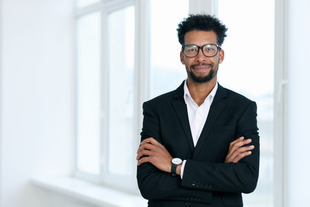 Portrait of man near window in office, space for text