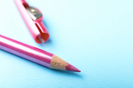 Eye pencil and sharpener on light blue background, closeup. Space for textの写真素材