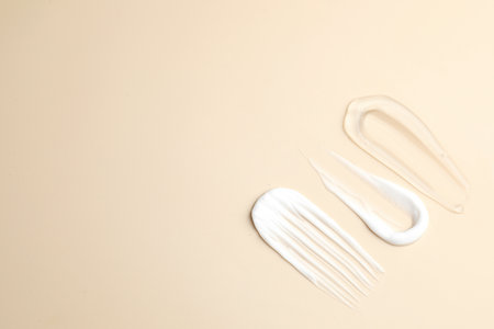 Samples of different cosmetic products on beige background, flat lay. Space for textの写真素材