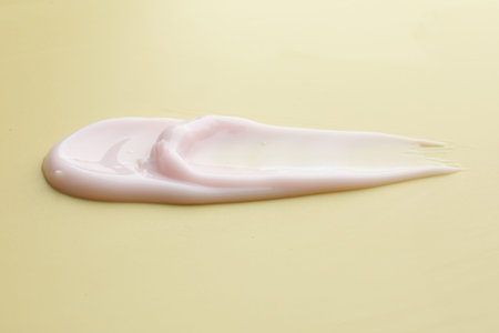Sample of cosmetic product on beige background, closeup