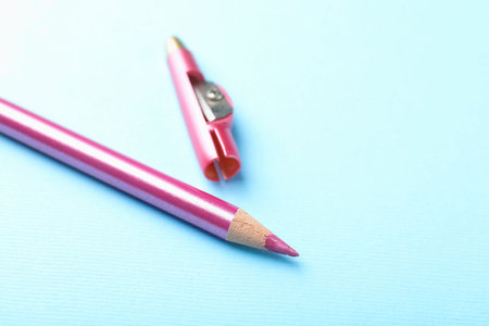 Pencil and sharpener on light blue background, closeup. Space for textの写真素材
