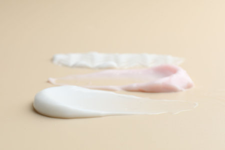 Samples of different cosmetic products on beige background, closeupの写真素材