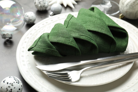 Festive table setting with Christmas tree made of napkin on gray background, closeupの写真素材