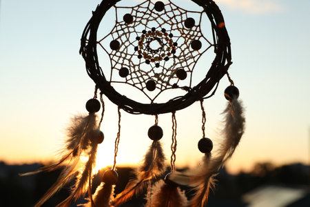 Shamanism. Beautiful dream catcher hanging outdoors, closeupの写真素材