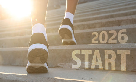 New 2026 Year. Teenage boy running up stairs with numbers and word Start outdoors, closeupの写真素材