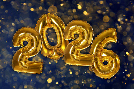 Happy New 2026 Year. Golden balloons in shape of numbers against dark background, bokeh lights. Greeting or invitation card designの写真素材
