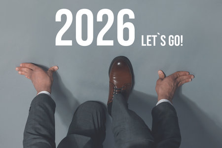 New 2026 Year. Businessman in starting position in front of numbers and phrase Let's Go! on floor, top viewの写真素材