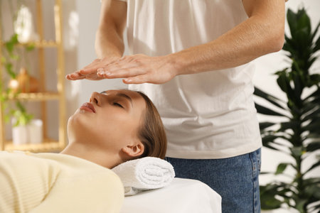 Reiki master healing patient's aura during therapy indoors, closeupの写真素材