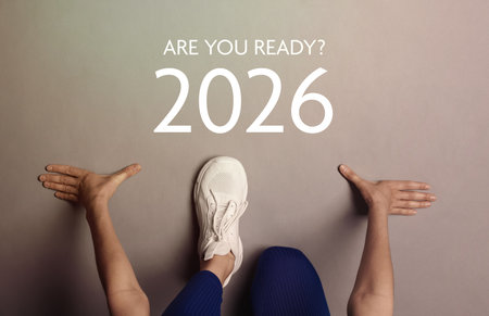 New 2026 Year. Woman in starting position in front of numbers and phrase Are You Ready? on floor, top viewの写真素材