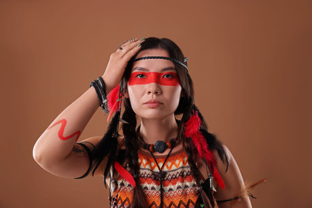 Shaman woman with face painting on brown background