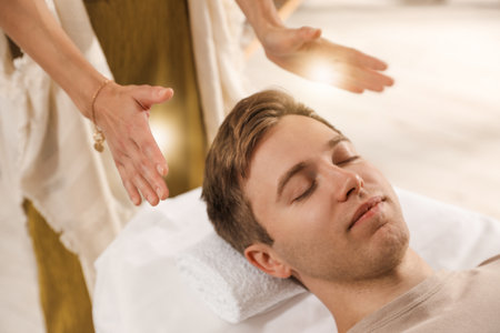 Reiki master healing patient's aura during therapy indoors, closeupの写真素材