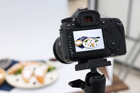 Shooting tasty croissants and ingredients with camera in studio, selective focus. Professional food...