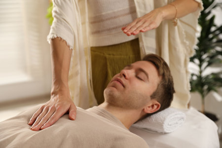 Reiki master healing patient's aura during therapy indoors, closeupの写真素材