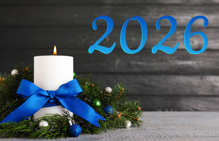 Happy New Year 2026 greeting card. Christmas composition with candles and balls