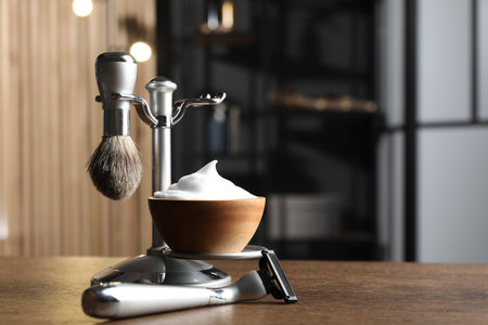 Metal stand with barber's tools on wooden table, closeup. Space for textの写真素材