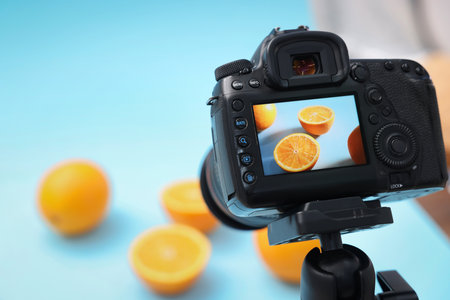 Shooting fresh oranges with camera in studio, selective focus. Professional food photographyの写真素材