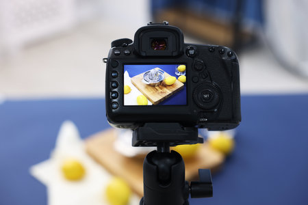 Shooting fresh lemons and juicer with camera in studio, selective focus. Professional food photographyの写真素材