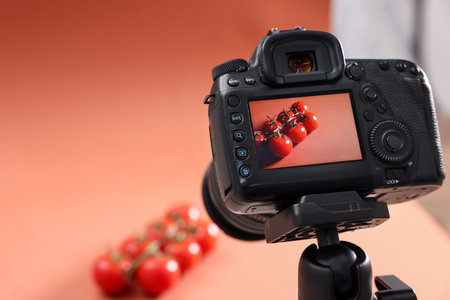 Shooting fresh tomatoes with camera in studio, selective focus. Professional food photographyの写真素材
