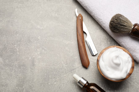 Different barber's tools on gray background, flat lay. Space for textの写真素材