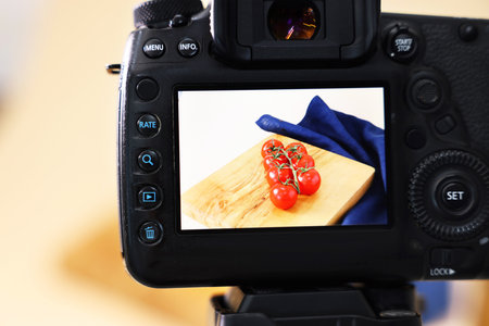 Shooting fresh tomatoes with camera in studio, selective focus. Professional food photographyの写真素材