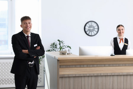 Receptionist and hostess working at reception in hotelの写真素材