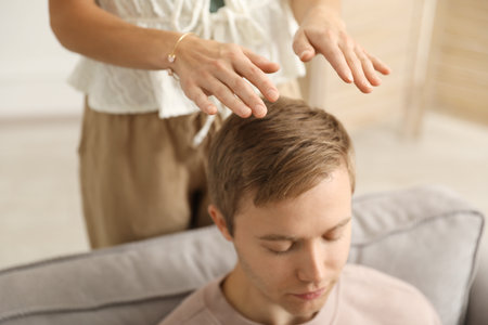 Reiki master healing patient's aura during therapy indoors, closeupの写真素材
