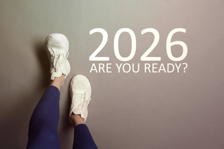 New 2026 Year. Woman near numbers and phrase Are You Ready? on floor, top view
