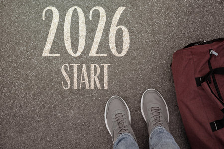 New 2026 Year. Man with bag standing in front of word Start and numbers on asphalt, top viewの写真素材