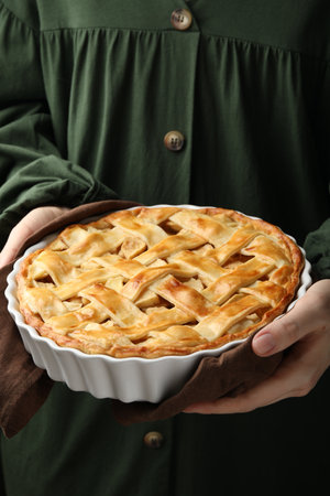 Woman with baking dish of delicious homemade apple pie, closeupの写真素材