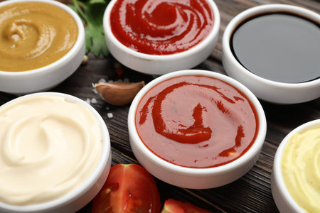 Different sauces and spices on wooden table, closeupの写真素材