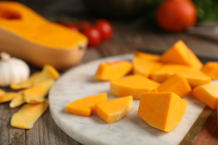Cut pumpkin, peels and ingredients on wooden table, closeupの写真素材