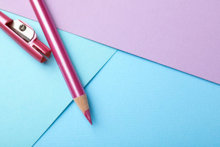 Pencil with sharpener on color background, flat lay. Space for textの写真素材